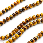Load image into Gallery viewer, Buddha Courage 108 Mala Beads Zoomed on Natural Tiger's Eye Beads Seen from front