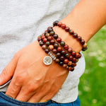Load image into Gallery viewer, Clarity of Mind of Life Tree 108 Beads Mala wear as bracelet on man model in garden
