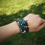 Load image into Gallery viewer, Longevity by Life Tree 108 Beads Mala Wear as bracelet by model in garden environment